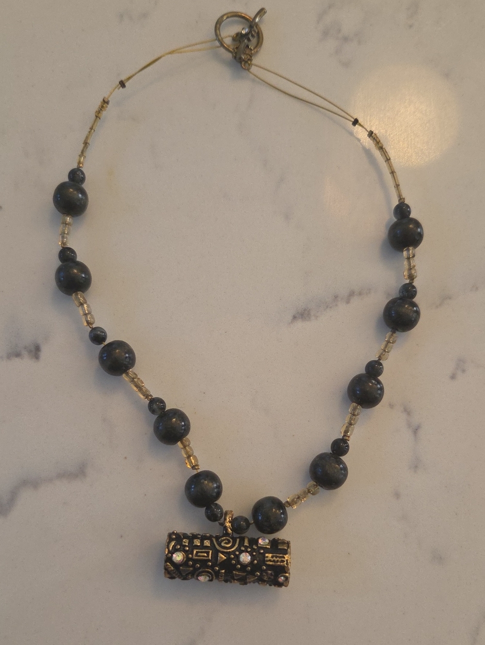 Handcrafted Black Bead Necklace with Gold Accent Pendant